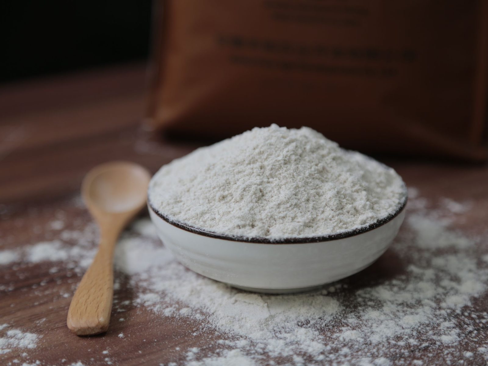 Bowl of ground calcium carbonate with a wooden scoop