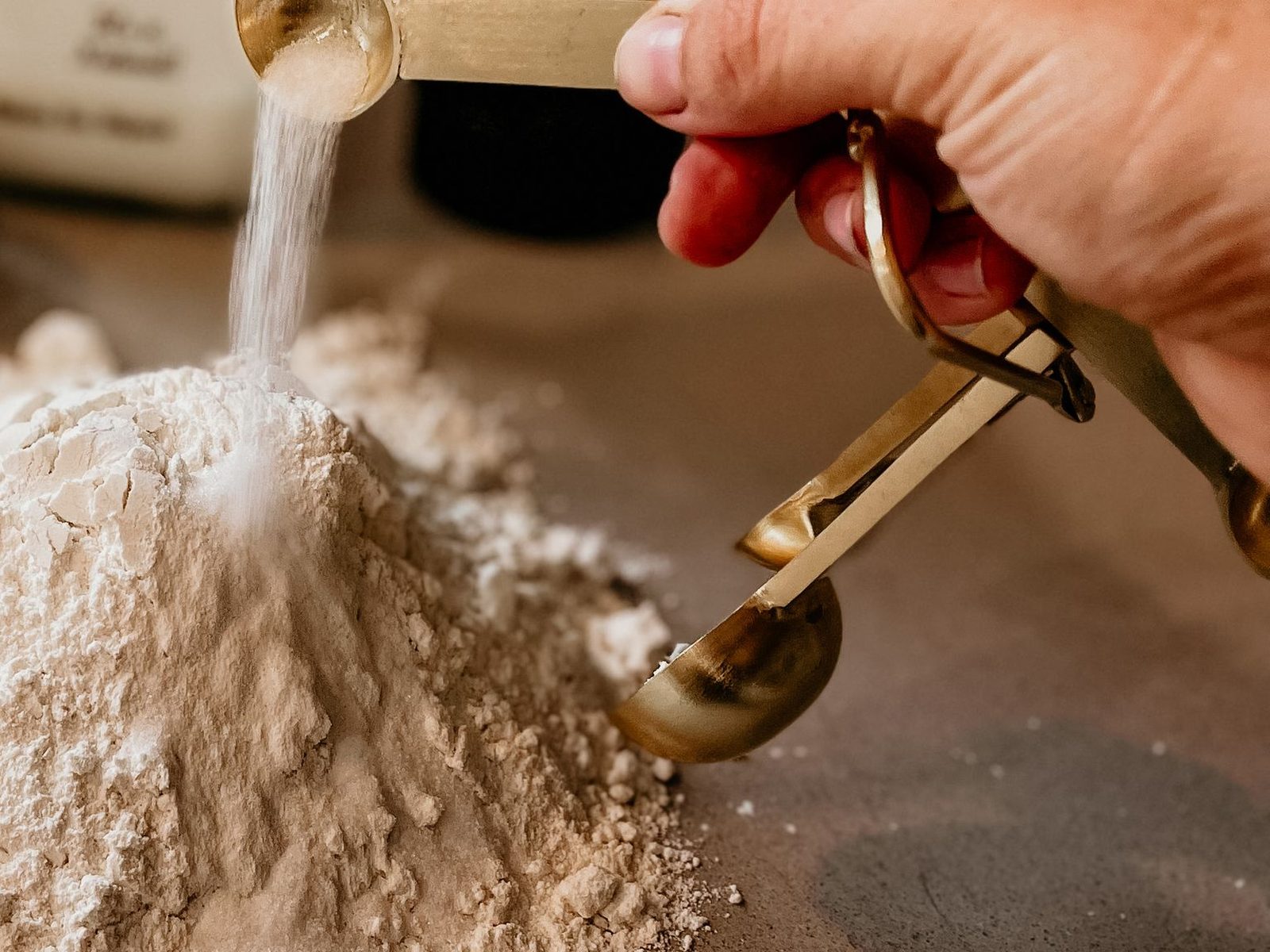 Soft white china clay powder being poured onto a heap