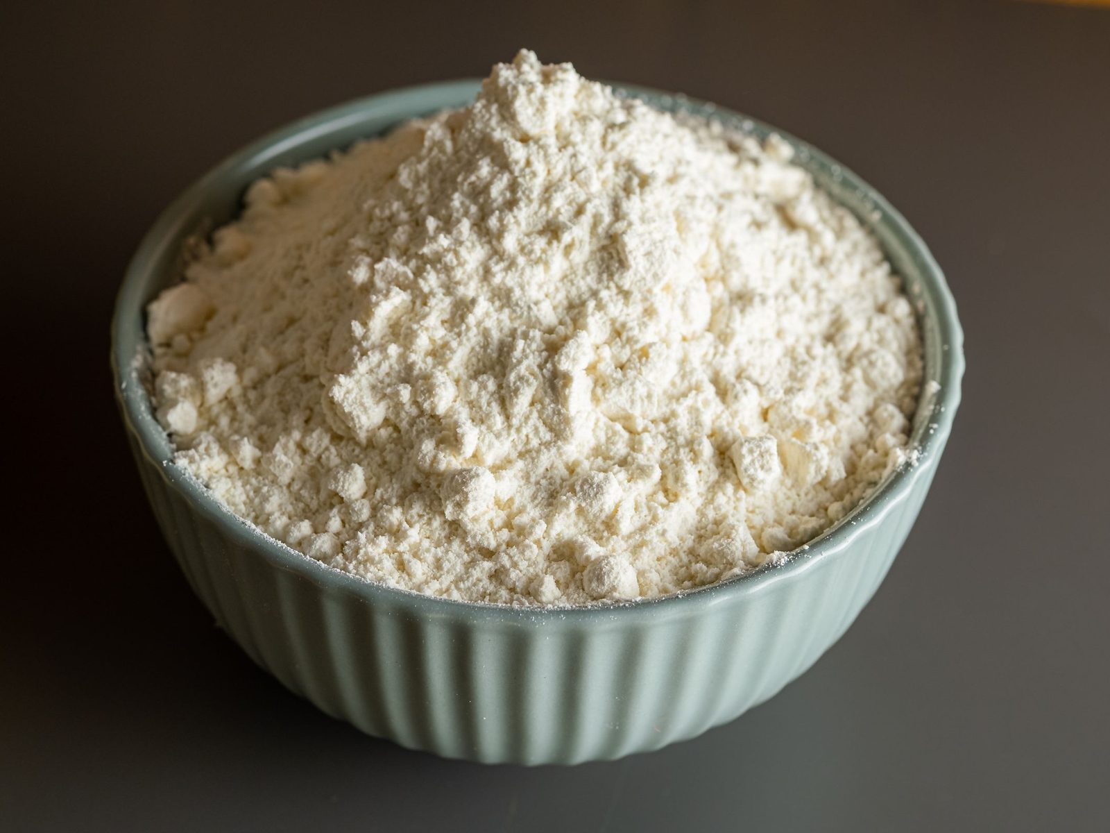 Bowl heaped with grey-white limestone powder
